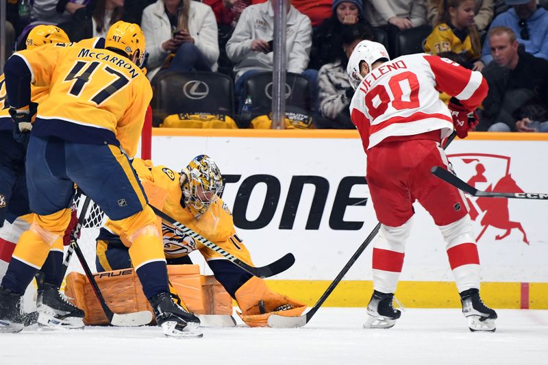 Mar 23, 2024; Nashville, Tennessee, USA; Nashville Predators goaltender Juuse Saros (74) makes a save on a shot by Detroit Red Wings center Joe Veleno (90) during the first period at Bridgestone Arena. Mandatory Credit: Christopher Hanewinckel-USA TODAY Sports