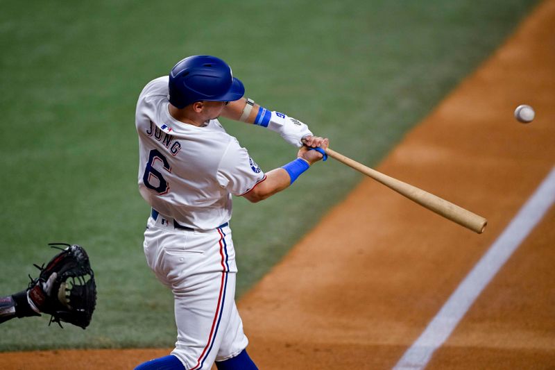 Aug 15, 2024; Arlington, Texas, USA; Texas Rangers third baseman Josh Jung (6) drives in a run against the Minnesota Twins during the first inning at Globe Life Field. Mandatory Credit: Jerome Miron-USA TODAY Sports