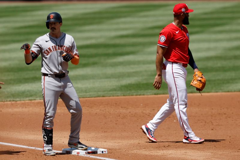 May 25, 2025; Washington, District of Columbia, USA; San Francisco Giants outfielder Mike Yastrzemski (5) gestures to his dugout after hitting a triple against the Washington Nationals during the third inning at Nationals Park. Mandatory Credit: Geoff Burke-Imagn Images