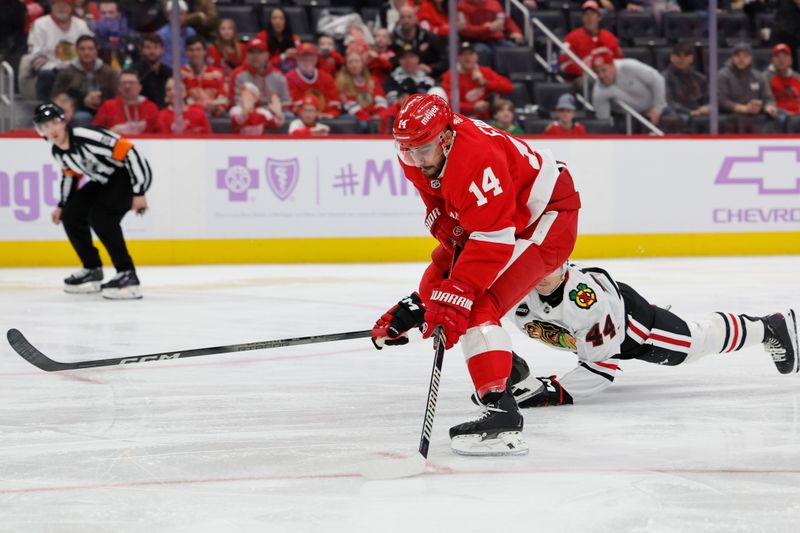 Nov 30, 2023; Detroit, Michigan, USA; Detroit Red Wings center Robby Fabbri (14) skates with the puck defended by Chicago Blackhawks defenseman Wyatt Kaiser (44) in the second period at Little Caesars Arena. Mandatory Credit: Rick Osentoski-USA TODAY Sports