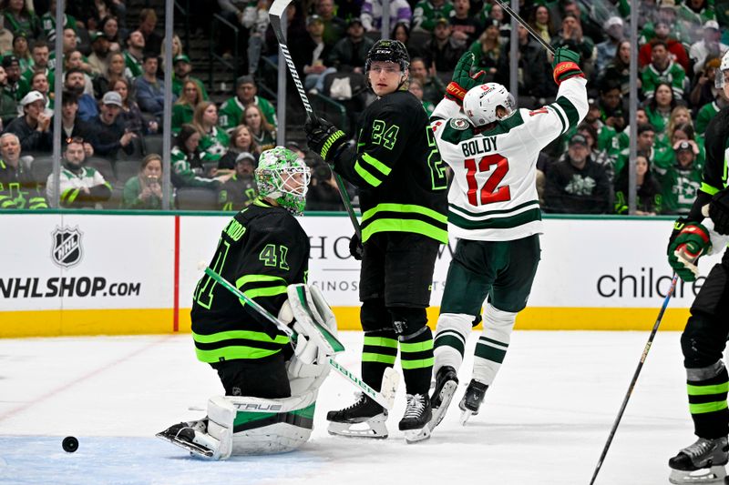 Jan 10, 2024; Dallas, Texas, USA; Minnesota Wild left wing Matt Boldy (12) celebrates scoring a goal as Dallas Stars goaltender Scott Wedgewood (41) and center Roope Hintz (24) look on during the third period at the American Airlines Center. Mandatory Credit: Jerome Miron-USA TODAY Sports