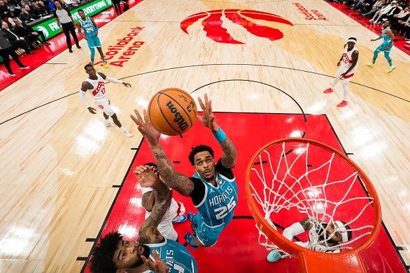 TORONTO, ON - DECEMBER 18:  P.J. Washington #25 of the Charlotte Hornets grabs a rebound against the Toronto Raptors during first half NBA action at Scotiabank Arena on December 18, 2023 in Toronto, Ontario, Canada. NOTE TO USER: User expressly acknowledges and agrees that, by downloading and/or using this Photograph, user is consenting to the terms and conditions of the Getty Images License Agreement. (Photo by Andrew Lahodynskyj/Getty Images)