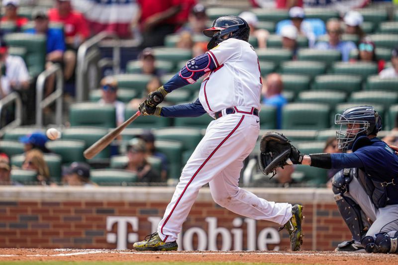 May 21, 2023; Cumberland, Georgia, USA; Atlanta Braves catcher Travis d'Arnaud (16) hits a home run against the Seattle Mariners during the sixth inning at Truist Park. Mandatory Credit: Dale Zanine-USA TODAY Sports