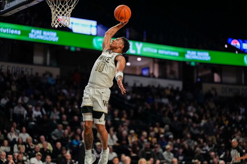 Nov 28, 2025; Winston-Salem, North Carolina, USA;  Wake Forest Demon Deacons guard Sebastian Akins (10) with a slam dunk against the Northeastern Huskies during the first half at Lawrence Joel Veterans Memorial Coliseum. Mandatory Credit: Jim Dedmon-Imagn Images