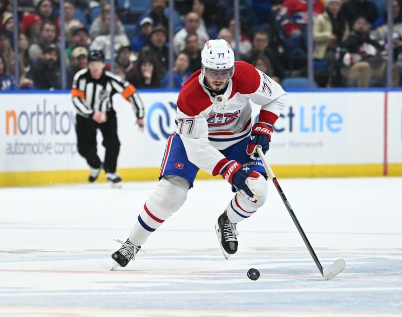 Nov 11, 2024; Buffalo, New York, USA; Montreal Canadiens center Kirby Dach (77) handles the puck in the first period against the Buffalo Sabres at KeyBank Center. Mandatory Credit: Mark Konezny-Imagn Images