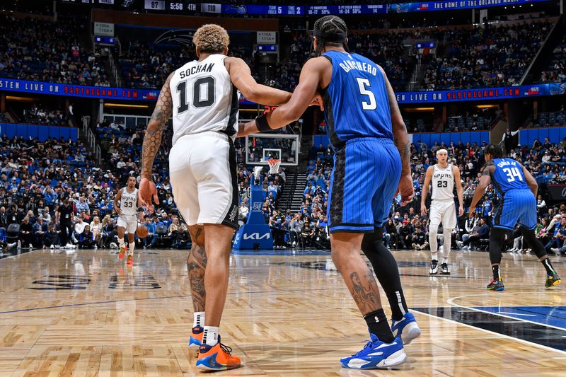 ORLANDO, FL - FEBRUARY 8: Paolo Banchero #5 of the Orlando Magic and Jeremy Sochan #10 of the San Antonio Spurs look on during the game on February 8, 2024 at the Kia Center in Orlando, Florida. NOTE TO USER: User expressly acknowledges and agrees that, by downloading and or using this photograph, User is consenting to the terms and conditions of the Getty Images License Agreement. Mandatory Copyright Notice: Copyright 2024 NBAE (Photo by Gary Bassing/NBAE via Getty Images)