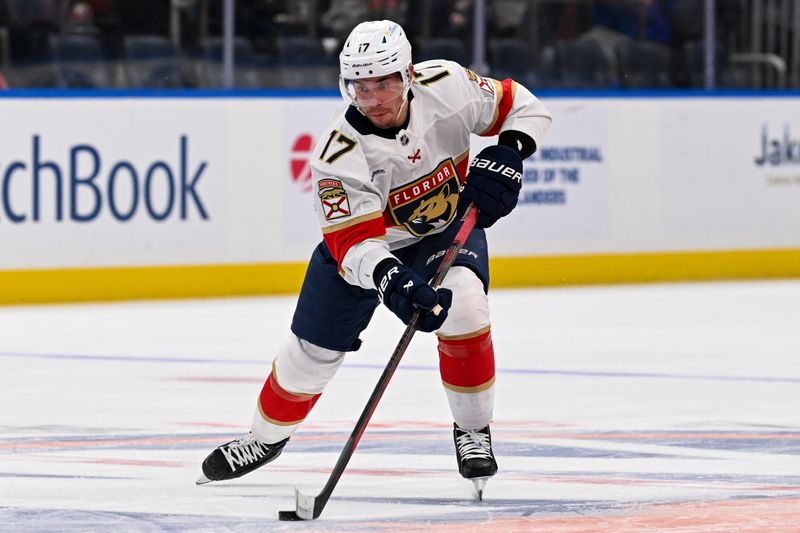 Oct 26, 2024; Elmont, New York, USA;  Florida Panthers center Evan Rodrigues (17) skates across center ice against the New York Islanders during the first period at UBS Arena. Mandatory Credit: Dennis Schneidler-Imagn Images