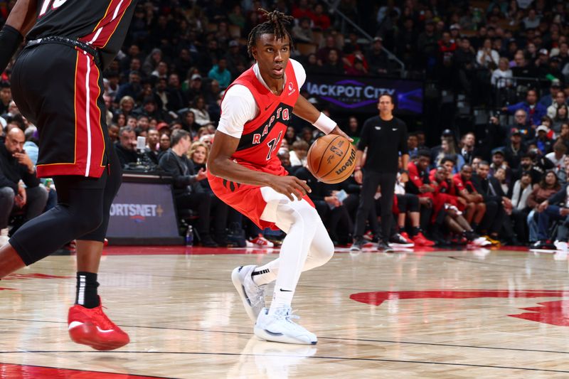 TORONTO, CANADA - DECEMBER 01:  Ja'Kobe Walter #14 of the Toronto Raptors dribbles  the ball during the game against the Miami Heat on December 1, 2024 at the Scotiabank Arena in Toronto, Ontario, Canada.  NOTE TO USER: User expressly acknowledges and agrees that, by downloading and or using this Photograph, user is consenting to the terms and conditions of the Getty Images License Agreement.  Mandatory Copyright Notice: Copyright 2024 NBAE (Photo by Vaughn Ridley/NBAE via Getty Images)