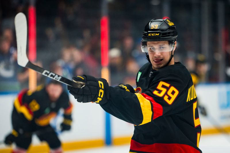 Oct 28, 2025; Vancouver, British Columbia, CAN; Vancouver Canucks defenseman Kirill Kudryavtsev (59) shoots during warm up prior to a game against the New York Rangers at Rogers Arena. Mandatory Credit: Bob Frid-Imagn Images