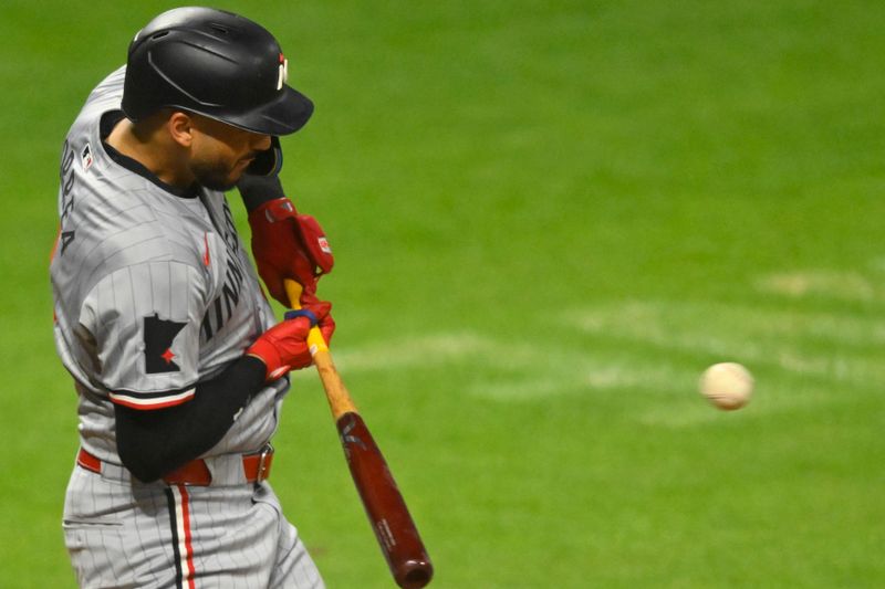 Sep 18, 2024; Cleveland, Ohio, USA; Minnesota Twins shortstop Carlos Correa (4) hits an RBI single in the fifth inning against the Cleveland Guardians at Progressive Field. Mandatory Credit: David Richard-Imagn Images