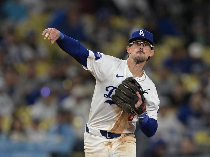 Jun 13, 2024; Los Angeles, California, USA; Los Angeles Los Angeles Dodgers third baseman Cavan Biggio (6) makes a play in the seventh inning against the Texas Rangers at Dodger Stadium. Mandatory Credit: Jayne Kamin-Oncea-USA TODAY Sports