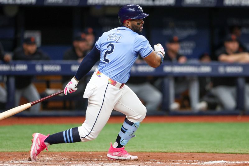 Apr 24, 2024; St. Petersburg, Florida, USA;  Tampa Bay Rays first baseman Yandy Diaz (2) hits an rbi single against the Detroit Tigers in the second inning at Tropicana Field. Mandatory Credit: Nathan Ray Seebeck-USA TODAY Sports