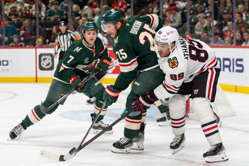 Oct 1, 2024; Saint Paul, Minnesota, USA; Minnesota Wild defenseman Jonas Brodin (25) checks Chicago Blackhawks center Andreas Athanasiou (89) in the first period at Xcel Energy Center. Mandatory Credit: Matt Blewett-Imagn Images