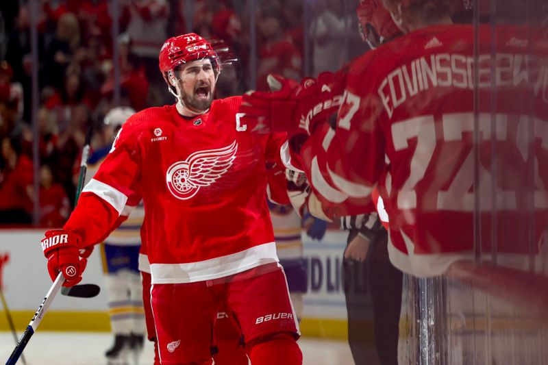 Apr 7, 2024; Detroit, Michigan, USA; Detroit Red Wings center Dylan Larkin (71) receives congratulations from teammates after scoring in the first period against the Buffalo Sabres at Little Caesars Arena. Mandatory Credit: Rick Osentoski-USA TODAY Sports