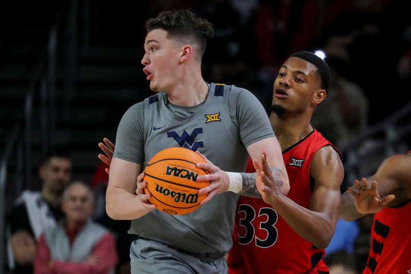 Mar 9, 2024; Cincinnati, Ohio, USA; West Virginia Mountaineers forward Quinn Slazinski (11) holds the ball against Cincinnati Bearcats forward Ody Oguama (33) in the first half at Fifth Third Arena. Mandatory Credit: Katie Stratman-USA TODAY Sports