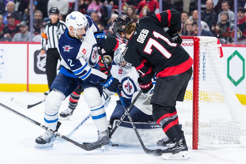 Feb 26, 2025; Ottawa, Ontario, CAN; Winnipeg Jets goalie Conno Hellebuyck (37) makes a save in front of Ottawa Senators center Ridly Greig (71) in the first period at the Canadian Tire Centre. Mandatory Credit: Marc DesRosiers-Imagn Images