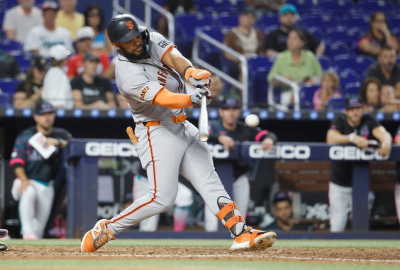 May 31, 2025; Miami, Florida, USA;  San Francisco Giants left fielder Heliot Ramos (17) singles against the Miami Marlins during the ninth inning at loanDepot Park. Mandatory Credit: Rhona Wise-Imagn Images