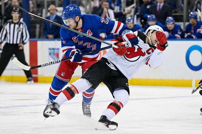 Dec 2, 2024; New York, New York, USA;  New York Rangers defenseman Adam Fox (23) checks New Jersey Devils center Nico Hischier (13) during the second period at Madison Square Garden. Mandatory Credit: Dennis Schneidler-Imagn Images