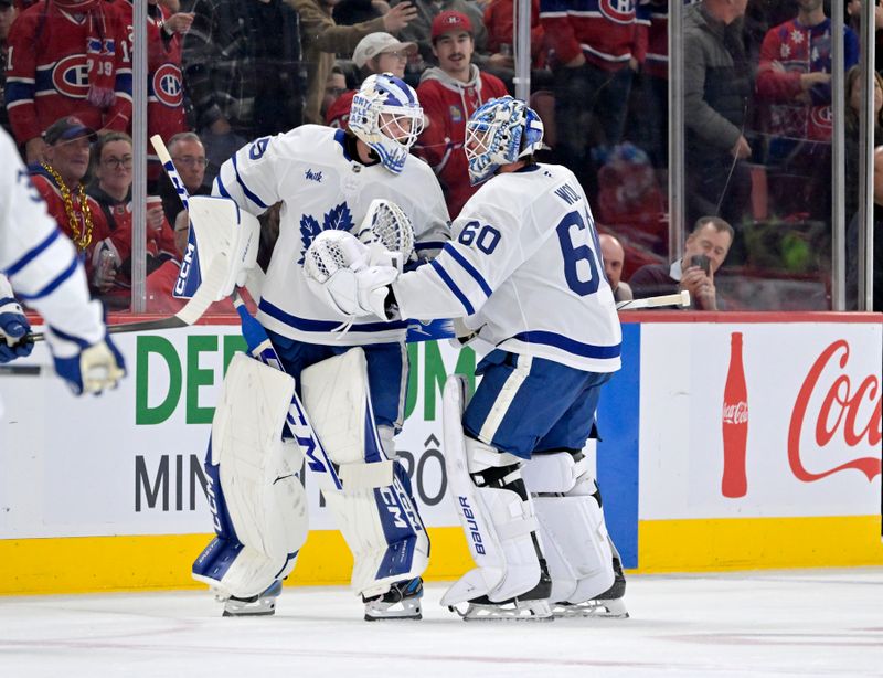 Nov 22, 2025; Montreal, Quebec, CAN; Toronto Maple Leafs goalie Dennis Hildeby (35) comes in to relieve teammate goalie Joseph Woll (60) during the second period of the game against the Montreal Canadiens at the Bell Centre. Mandatory Credit: Eric Bolte-Imagn Images