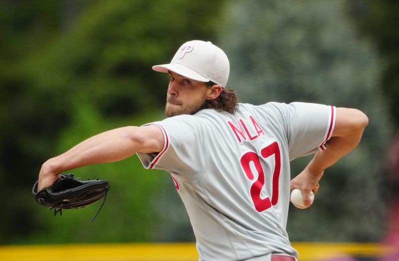 May 14, 2023; Denver, Colorado, USA; Philadelphia Phillies starting pitcher Aaron Nola (27) delivers a pitch in the first inning against the Colorado Rockies at Coors Field. Mandatory Credit: Ron Chenoy-USA TODAY Sports