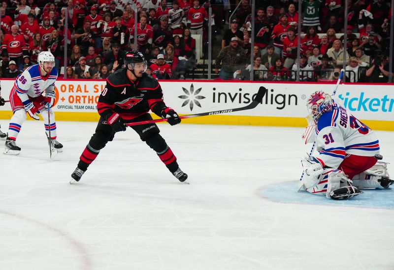 May 16, 2024; Raleigh, North Carolina, USA; Carolina Hurricanes center Sebastian Aho (20) misses on his scoring attempt against New York Rangers goaltender Igor Shesterkin (31) during the third period in game six of the second round of the 2024 Stanley Cup Playoffs at PNC Arena. Mandatory Credit: James Guillory-USA TODAY Sports