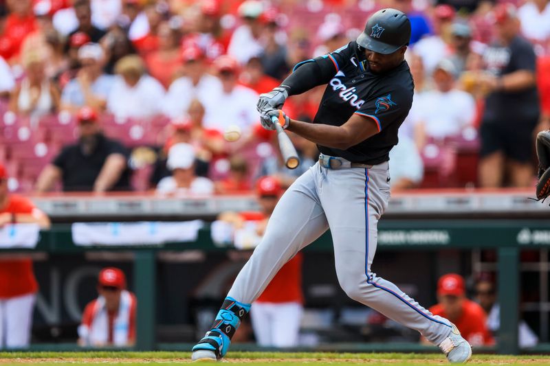 Jul 14, 2024; Cincinnati, Ohio, USA; Miami Marlins outfielder Jesus Sanchez (12) hits a double in the fifth inning against the Cincinnati Reds at Great American Ball Park. Mandatory Credit: Katie Stratman-USA TODAY Sports