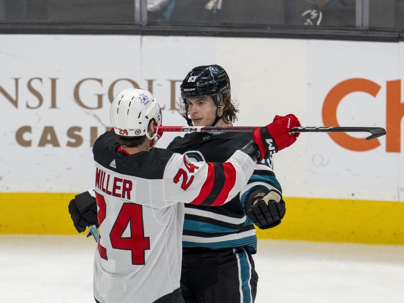 Feb 27, 2024; San Jose, California, USA;  San Jose Sharks defenseman Nikita Okhotiuk (83) and New Jersey Devils defenseman Colin Miller (24) fight during the third period and  at SAP Center at San Jose. Mandatory Credit: Neville E. Guard-USA TODAY Sports