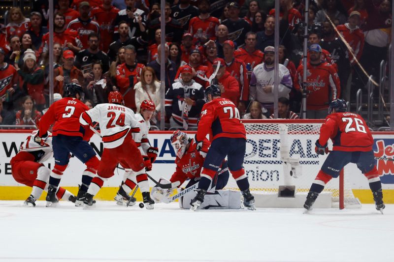 May 8, 2025; Washington, District of Columbia, USA; Washington Capitals goaltender Logan Thompson (48) makes a save on Carolina Hurricanes center Seth Jarvis (24) in the third period in game two of the second round of the 2025 Stanley Cup Playoffs at Capital One Arena. Mandatory Credit: Geoff Burke-Imagn Images