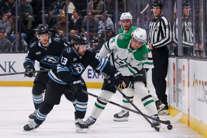 Jan 15, 2026; Salt Lake City, Utah, USA; Utah Mammoth left wing Michael Carcone (53) and Dallas Stars center Roope Hintz (24) battle for the puck during the third period at Delta Center. Mandatory Credit: Rob Gray-Imagn Images