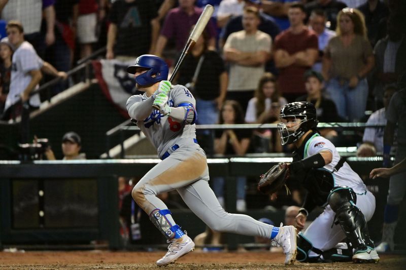 Oct 11, 2023; Phoenix, Arizona, USA; Los Angeles Dodgers shortstop Enrique Hernandez (8) hits a RBI single against the Arizona Diamondbacks in the seventh inning for game three of the NLDS for the 2023 MLB playoffs at Chase Field. Mandatory Credit: Matt Kartozian-USA TODAY Sports