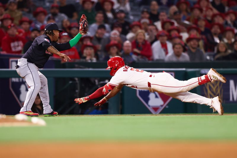 May 24, 2024; Anaheim, California, USA; Los Angeles Angels second base Luis Rengifo (2) dives into third base during the fifth inning of a game against the Cleveland Guardians at Angel Stadium. Mandatory Credit: Jessica Alcheh-USA TODAY Sports