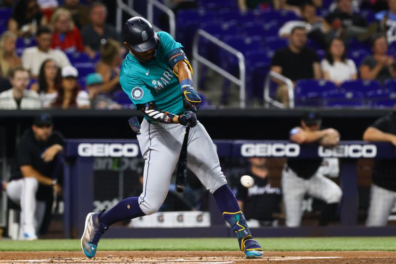 Jun 21, 2024; Miami, Florida, USA; Seattle Mariners center fielder Julio Rodriguez (44) hits an RBI single against the Miami Marlins during the first inning at loanDepot Park. Mandatory Credit: Sam Navarro-USA TODAY Sports