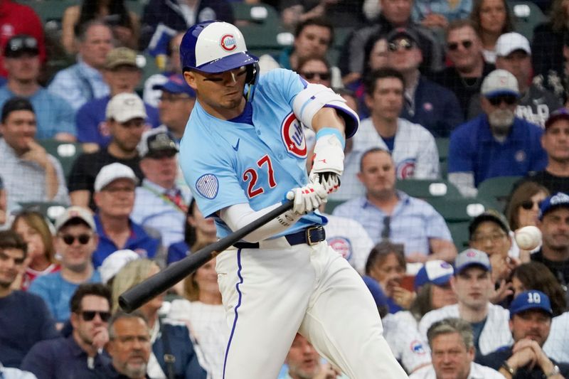 May 30, 2025; Chicago, Illinois, USA; Chicago Cubs outfielder Seiya Suzuki (27) hits a double against the Cincinnati Reds during the ninth inning at Wrigley Field. Mandatory Credit: David Banks-Imagn Images