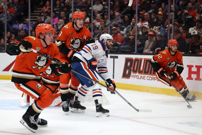 Feb 25, 2026; Anaheim, California, USA;  Anaheim Ducks center Leo Carlsson (91) and Edmonton Oilers center Adam Henrique (19) fight for position during the first period at Honda Center. Mandatory Credit: Kiyoshi Mio-Imagn Images
