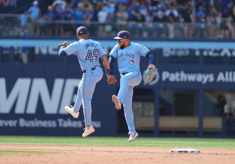 Aug 25, 2024; Toronto, Ontario, CAN; Toronto Blue Jays shortstop Leo Jimenez (49) celebrates the win with outfielder Steward Berroa (37) against the Los Angeles Angels at the end of the ninth inning at Rogers Centre. Mandatory Credit: Nick Turchiaro-USA TODAY Sports