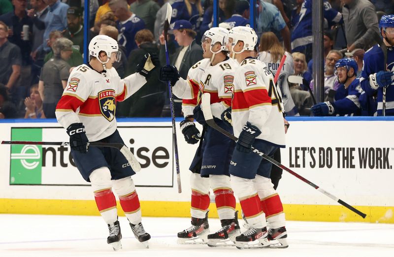 Apr 25, 2024; Tampa, Florida, USA; Florida Panthers left wing Matthew Tkachuk (19) is congratulated by center Anton Lundell (15) and defenseman Gustav Forsling (42) after he scored a goal against the Tampa Bay Lightning during the third period in game three of the first round of the 2024 Stanley Cup Playoffs at Amalie Arena. Mandatory Credit: Kim Klement Neitzel-USA TODAY Sports