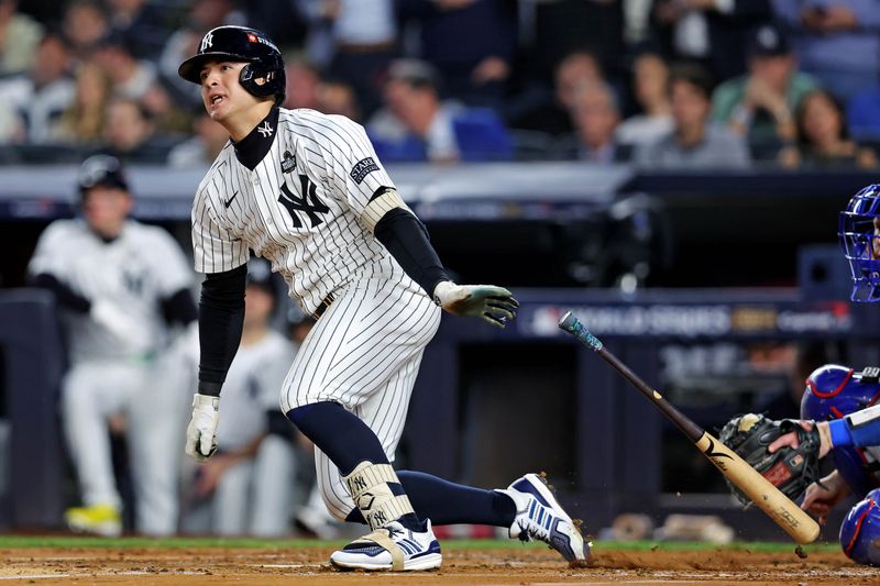 Oct 30, 2024; New York, New York, USA; New York Yankees shortstop Anthony Volpe (11) hits a double during the second inning against the Los Angeles Dodgers in game four of the 2024 MLB World Series at Yankee Stadium. Mandatory Credit: Brad Penner-Imagn Images