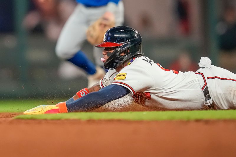 Sep 27, 2023; Cumberland, Georgia, USA; Atlanta Braves right fielder Ronald Acuna Jr. (13) steals a base against the Chicago Cubs during the eighth inning at Truist Park. Mandatory Credit: Dale Zanine-USA TODAY Sports