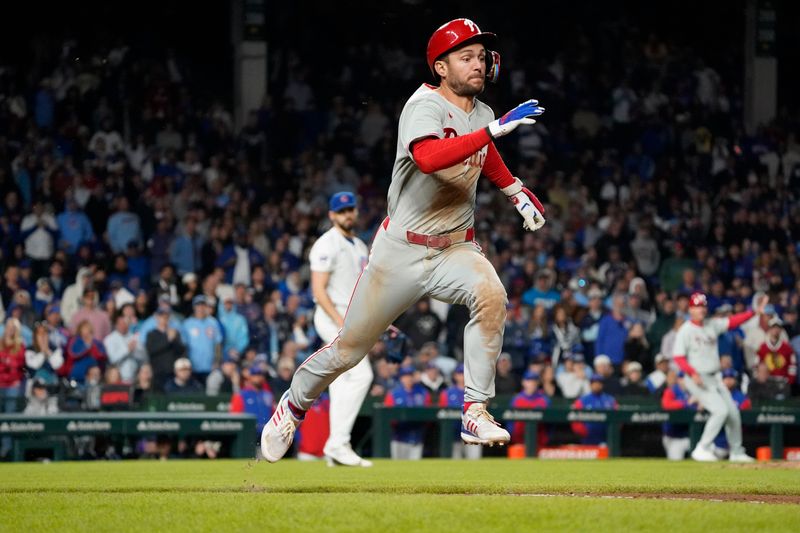 Apr 27, 2025; Chicago, Illinois, USA; Philadelphia Phillies shortstop Trea Turner (7) beats out a one run infield single against the Chicago Cubs during the tenth inning at Wrigley Field. Mandatory Credit: David Banks-Imagn Images