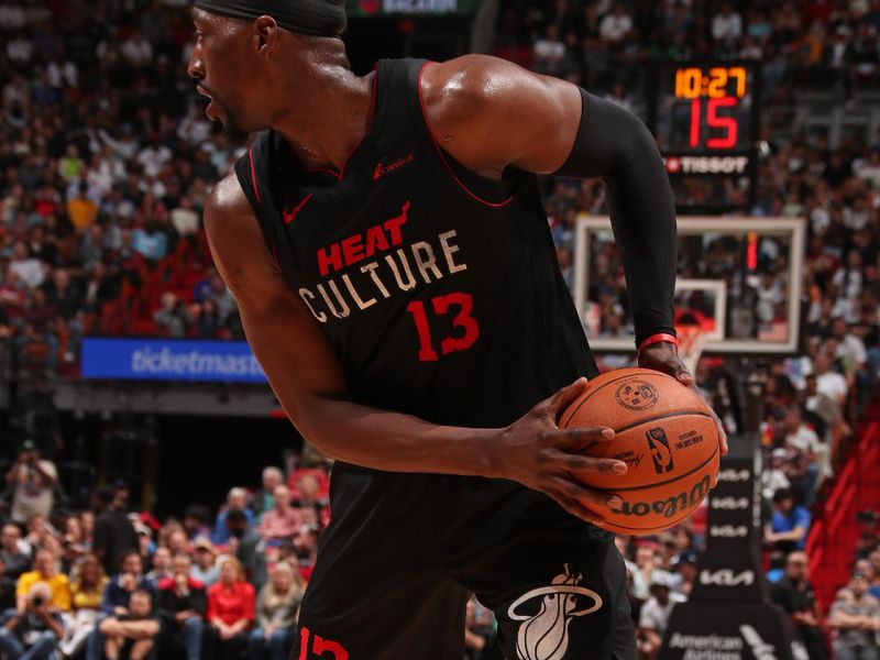 MIAMI, FL - MARCH 26:  Bam Adebayo #13 of the Miami Heat handles the ball during the game against the Golden State Warriors on March 26, 2024 at Kaseya Center in Miami, Florida. NOTE TO USER: User expressly acknowledges and agrees that, by downloading and or using this Photograph, user is consenting to the terms and conditions of the Getty Images License Agreement. Mandatory Copyright Notice: Copyright 2024 NBAE (Photo by Issac Baldizon/NBAE via Getty Images)