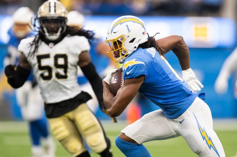 Los Angeles Chargers wide receiver Quentin Johnston (1) runs with the ball during an NFL preseason football game against the New Orleans Saints, Sunday, Aug. 20, 2023, in Inglewood, Calif. (AP Photo/Kyusung Gong)