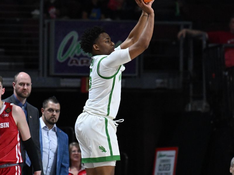 Mar 28, 2023; Las Vegas, NV, USA; North Texas Mean Green guard Tylor Perry (5) shoots the ball against the Wisconsin Badgers in the first half at Orleans Arena. Mandatory Credit: Candice Ward-USA TODAY Sports