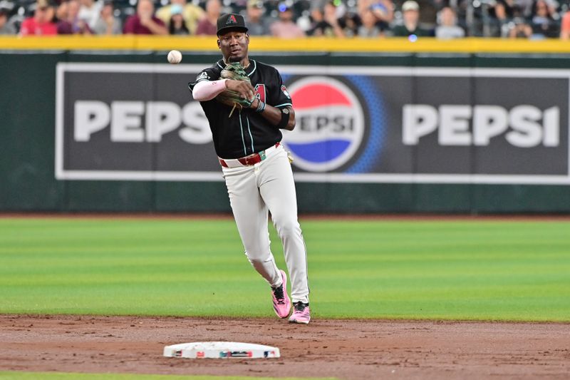 Aug 29, 2024; Phoenix, Arizona, USA;  Arizona Diamondbacks shortstop Geraldo Perdomo (2) throws to first base in the second inning against the New York Mets at Chase Field. Mandatory Credit: Matt Kartozian-USA TODAY Sports