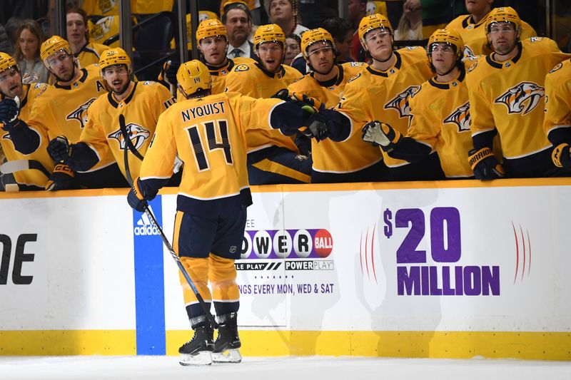 Jan 2, 2024; Nashville, Tennessee, USA; Nashville Predators center Gustav Nyquist (14) celebrates with teammates after a goal during the first period against the Chicago Blackhawks at Bridgestone Arena. Mandatory Credit: Christopher Hanewinckel-USA TODAY Sports