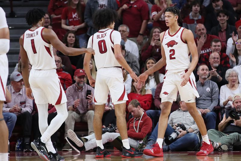 Dec 3, 2022; Fayetteville, Arkansas, USA; Arkansas Razorbacks guards Ricky Council IV (1) and Anthony Black (0) celebrate with forward Trevon Brazile (2) during the second half against the San Jose State Spartans at Bud Walton Arena. Arkansas won 99-58. Mandatory Credit: Nelson Chenault-USA TODAY Sports