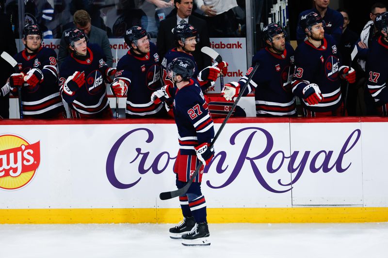 Mar 12, 2026; Winnipeg, Manitoba, CAN; Winnipeg Jets forward Isak Rosen (27) is congratulated by his team mates on his goal against the New York Rangers during the second period at Canada Life Centre. Mandatory Credit: Terrence Lee-Imagn Images