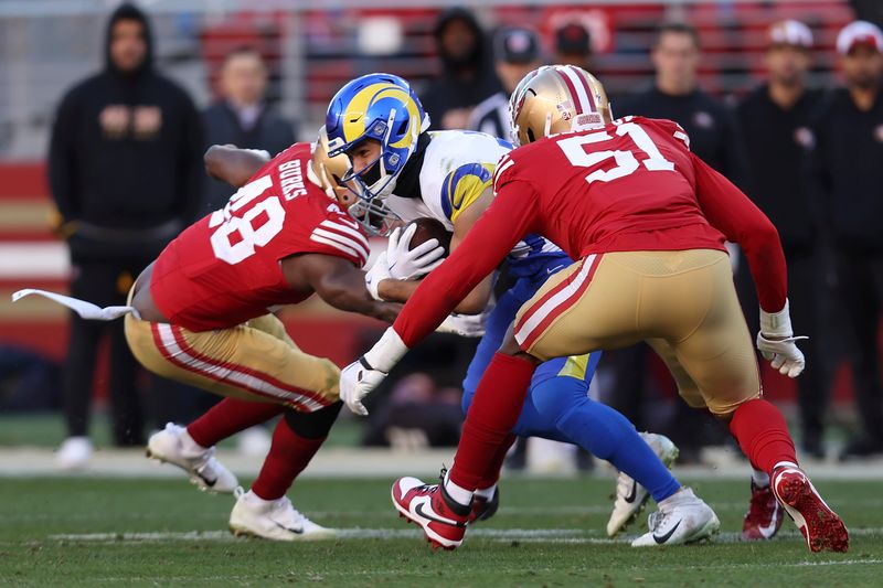 Los Angeles Rams wide receiver Puka Nacua, middle, runs after catching a pass against the San Francisco 49ers during the second half of an NFL football game in Santa Clara, Calif., Sunday, Jan. 7, 2024. Nacua set a rookie record for receiving yards on this play. (AP Photo/Jed Jacobsohn)