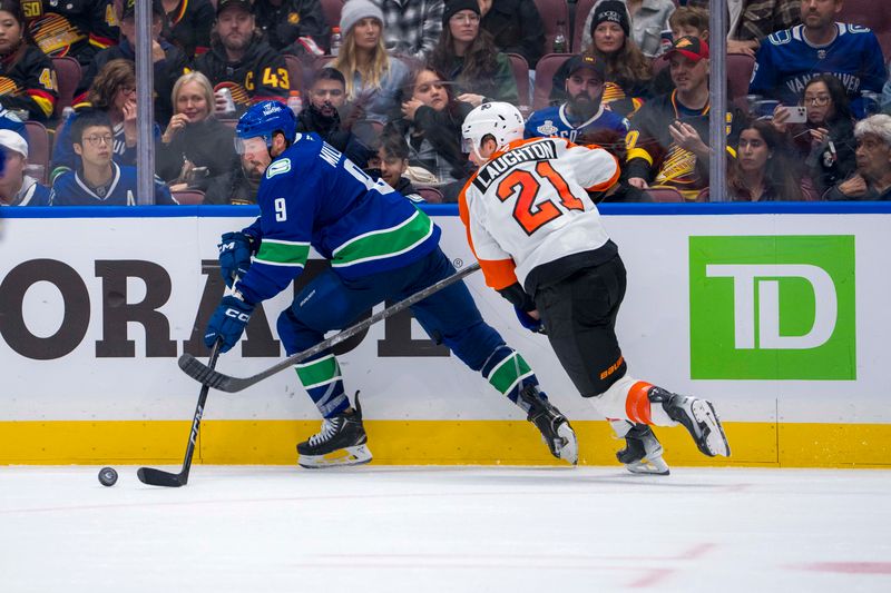 Oct 11, 2024; Vancouver, British Columbia, CAN; Philadelphia Flyers forward Scott Laughton (21) stick checks Vancouver Canucks forward J.T. Miller (9) during the third period at Rogers Arena. Mandatory Credit: Bob Frid-Imagn Images