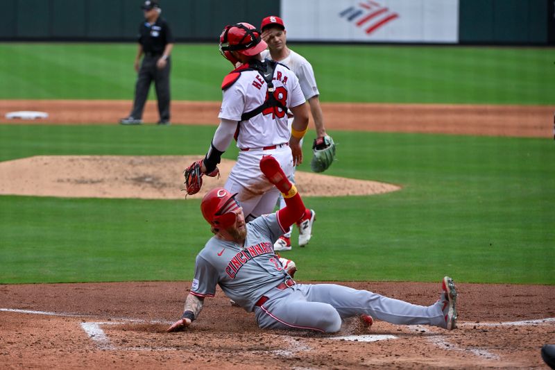 Sep 12, 2024; St. Louis, Missouri, USA;  Cincinnati Reds right fielder Jake Fraley (27) slides safely in at home to score against the St. Louis Cardinals during the sixth inning at Busch Stadium. Mandatory Credit: Jeff Curry-Imagn Images