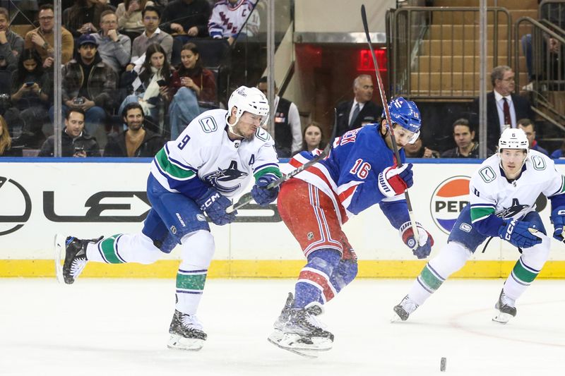 Jan 8, 2024; New York, New York, USA;  Vancouver Canucks center J.T. Miller (9) and New York Rangers center Vincent Trocheck (16) chases the puck in the first period at Madison Square Garden. Mandatory Credit: Wendell Cruz-USA TODAY Sports